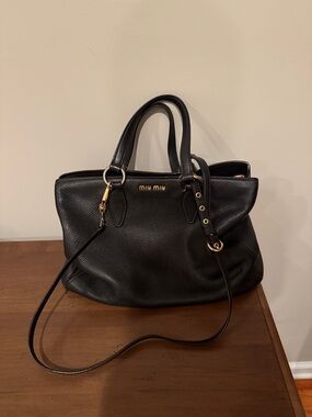 Miu Miu Black Pebbled Leather Top-Handle Shoulder Bag
Comes with dust bag